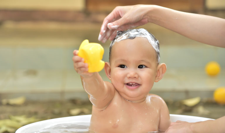 Baby boy playing with a rubber ducky