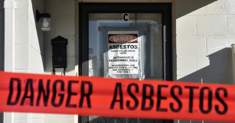 Asbestos notification posted on an apartment's door