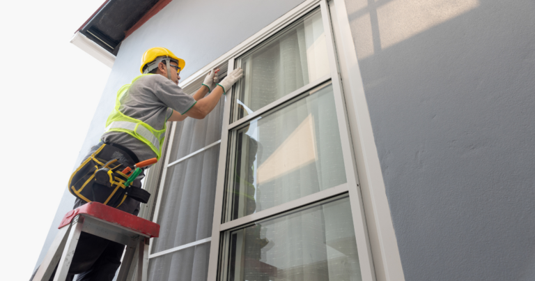 A construction worker installing new vinyl windows