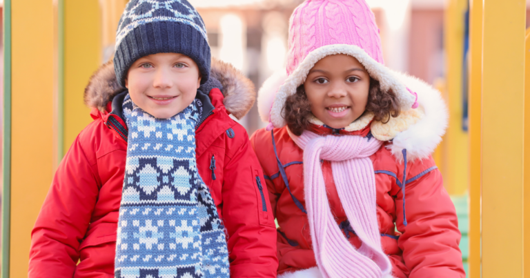 Two kids wearing water-resistant winter coats and hats